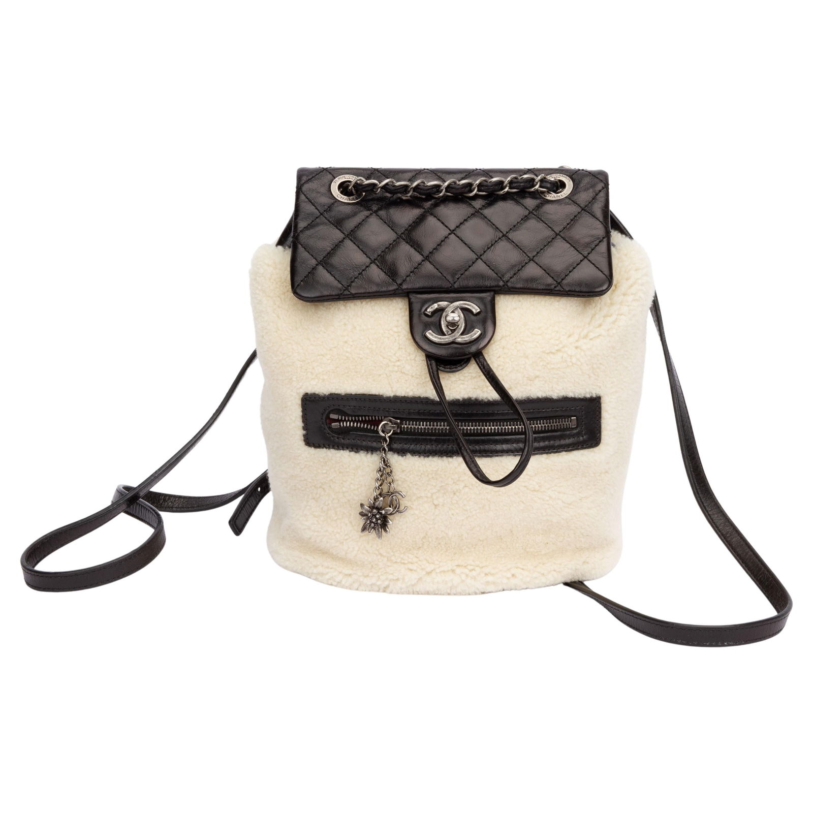 Chanel Black Shearling Backpack with Dust Cover and Card: Chanel Black Shearling Backpack with Dust Cover and Card Discover the elegance of this Chanel Black Shearling Mint Backpack, crafted from luxurious black brushed leather and plush shearling. This styl