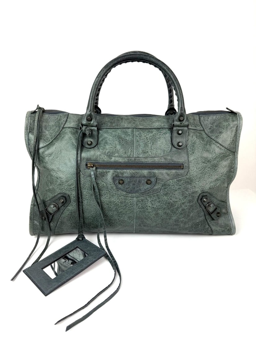 Balenciaga City Large Distressed Green Leather Tote with Mirror and Dust Bag: Balenciaga City Large Distressed Green Leather Tote with Mirror and Dust Bag This Balenciaga City Work Tote is crafted from dark green distressed leather and features a rectangular silhouette with dou