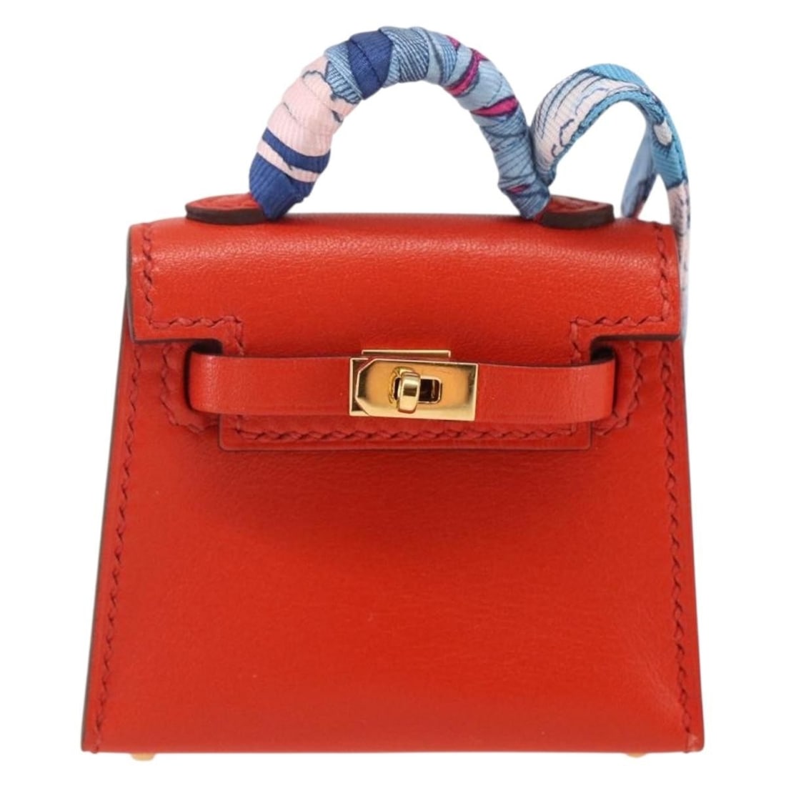 Leather Kelly Twilly Charm by Hermes Orange 6cm by 24cm: Leather Kelly Twilly Charm by Hermes Orange 6cm by 24cm This Hermes Kelly Twilly bag charm in vibrant orange leather is designed for women. It features a sleek, durable leather construction with dimen