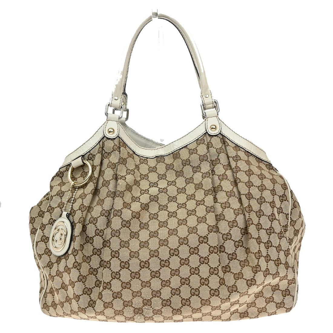 Sukey GG Canvas Shoulder Purse by Gucci in Brown: Sukey GG Canvas Shoulder Purse by Gucci in Brown This Gucci Sukey shoulder bag is crafted from brown GG canvas and designed for women. It features gold-plated hardware and has a spacious interior. The