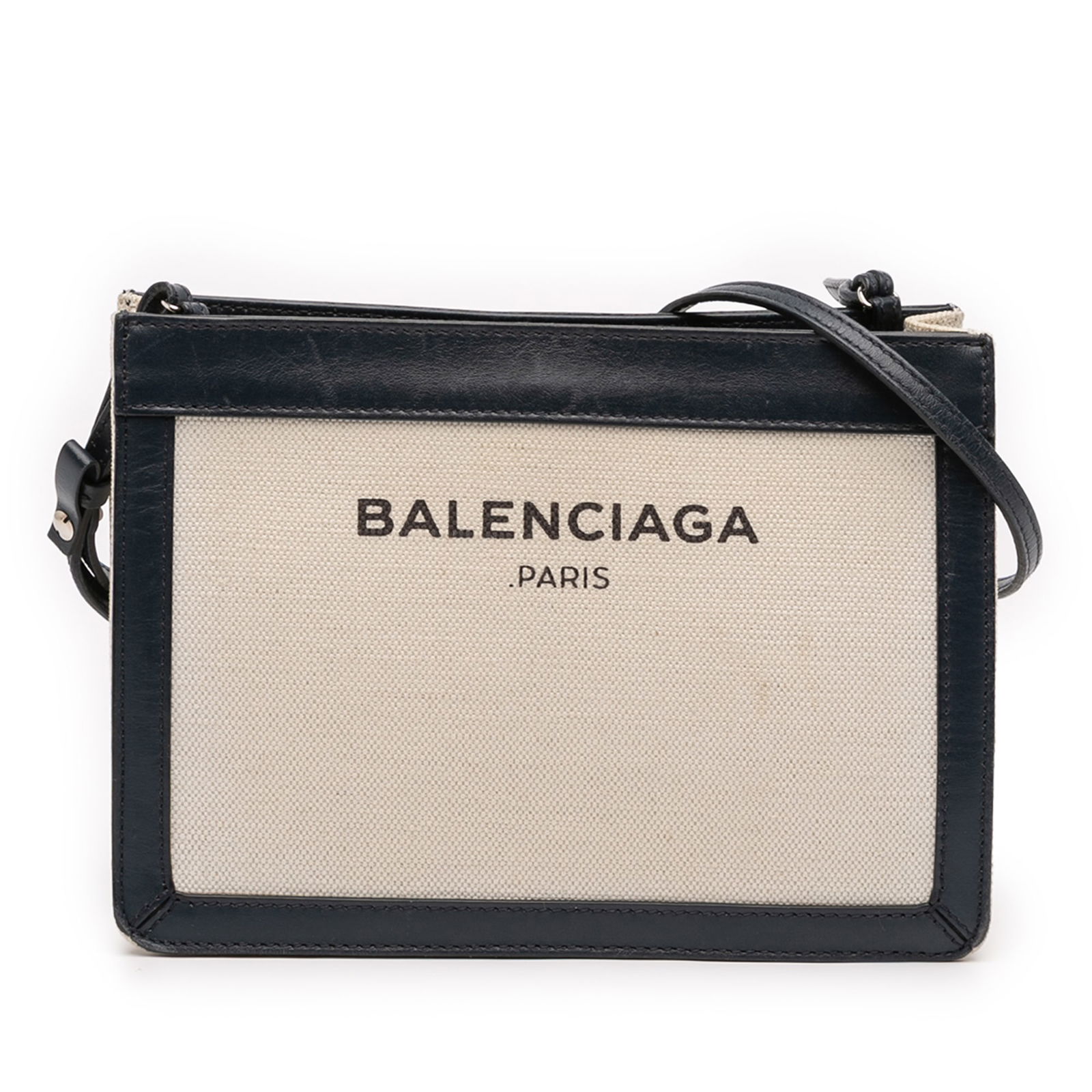 Balenciaga Navy Canvas Pochette Crossbody Bag with Leather Trim: Balenciaga Navy Canvas Pochette Crossbody Bag with Leather Trim The Balenciaga Canvas Navy Pochette Crossbody features a durable canvas body with leather trim and an adjustable flat leather shoulder s