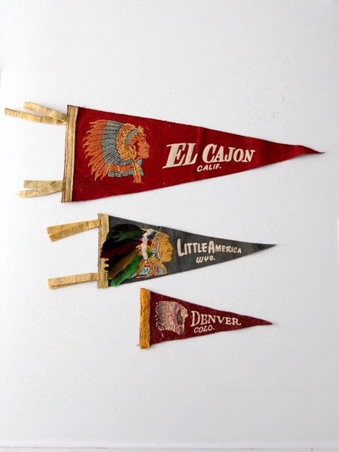 Vintage Collection of 3 Indian Head Felt Pendants: Vintage Collection of 3 Indian Head Felt Pendants Discover a unique collection of three vintage Indian head felt pendants, perfect for any memorabilia enthusiast. The first pendant, in vibrant red, ha