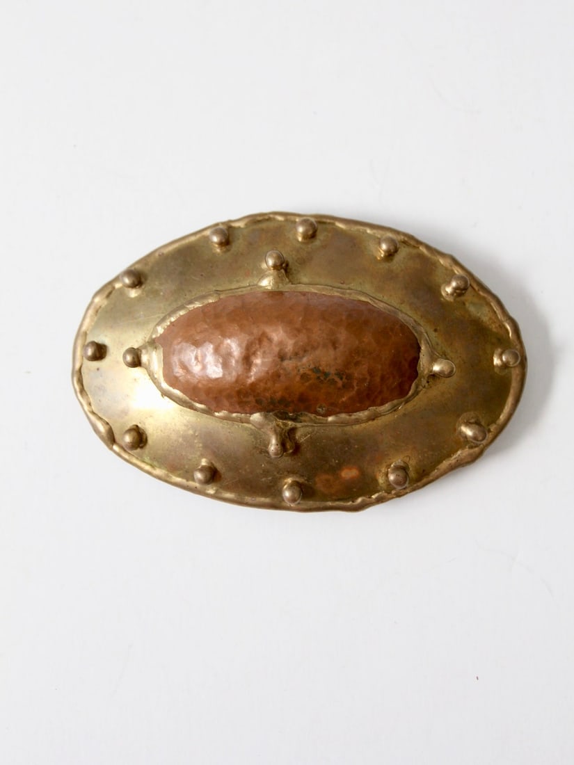 Vintage Brutalist Brass Copper Studded Belt Buckle: Vintage Brutalist Brass Copper Studded Belt Buckle Discover a striking vintage brutalist belt buckle, crafted from brass and copper. This large buckle showcases a unique studded design, perfect for ad