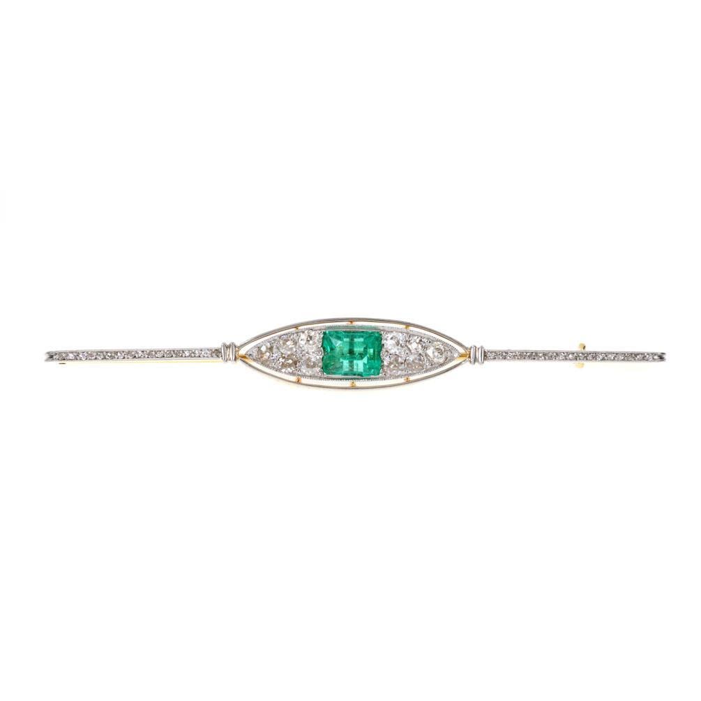 Art Deco 4.80ct Old Mine Cut Diamond Emerald Brooch in Platinum 18k Gold: Art Deco 4.80ct Old Mine Cut Diamond Emerald Brooch in Platinum 18k Gold This exquisite Art Deco long brooch is a striking piece, meticulously crafted from 18k yellow gold and platinum. It features a