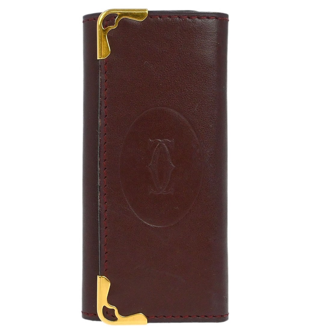 Must de Cartier Bordeaux Leather Key Holder Accessory: Must de Cartier Bordeaux Leather Key Holder Accessory This vintage Cartier Bordeaux Must de Cartier key case is crafted from leather in a rich Bordeaux color. It features a button logo accent and is m