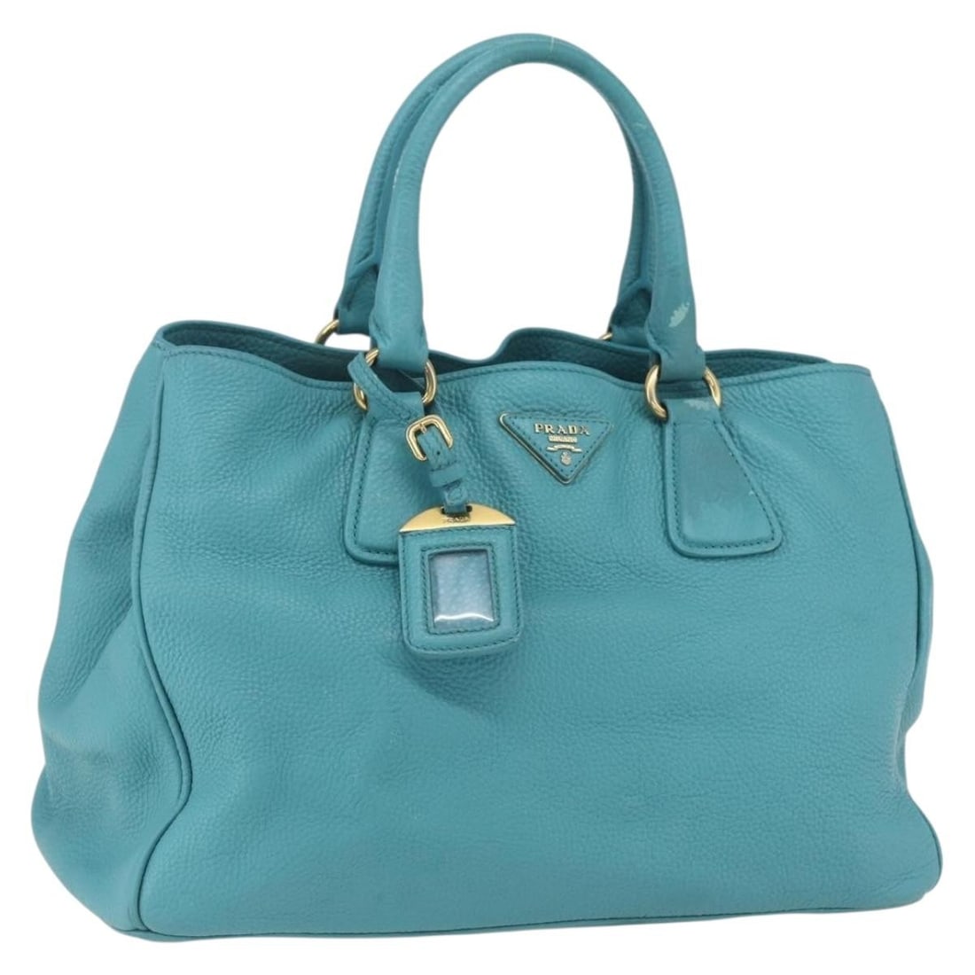 Light Blue Leather PRADA Handbag with Gold Accents and Name Tag: Light Blue Leather PRADA Handbag with Gold Accents and Name Tag This PRADA handbag features light blue leather with gold-tone accents. The bag includes a name tag accessory and is made in Italy. It is