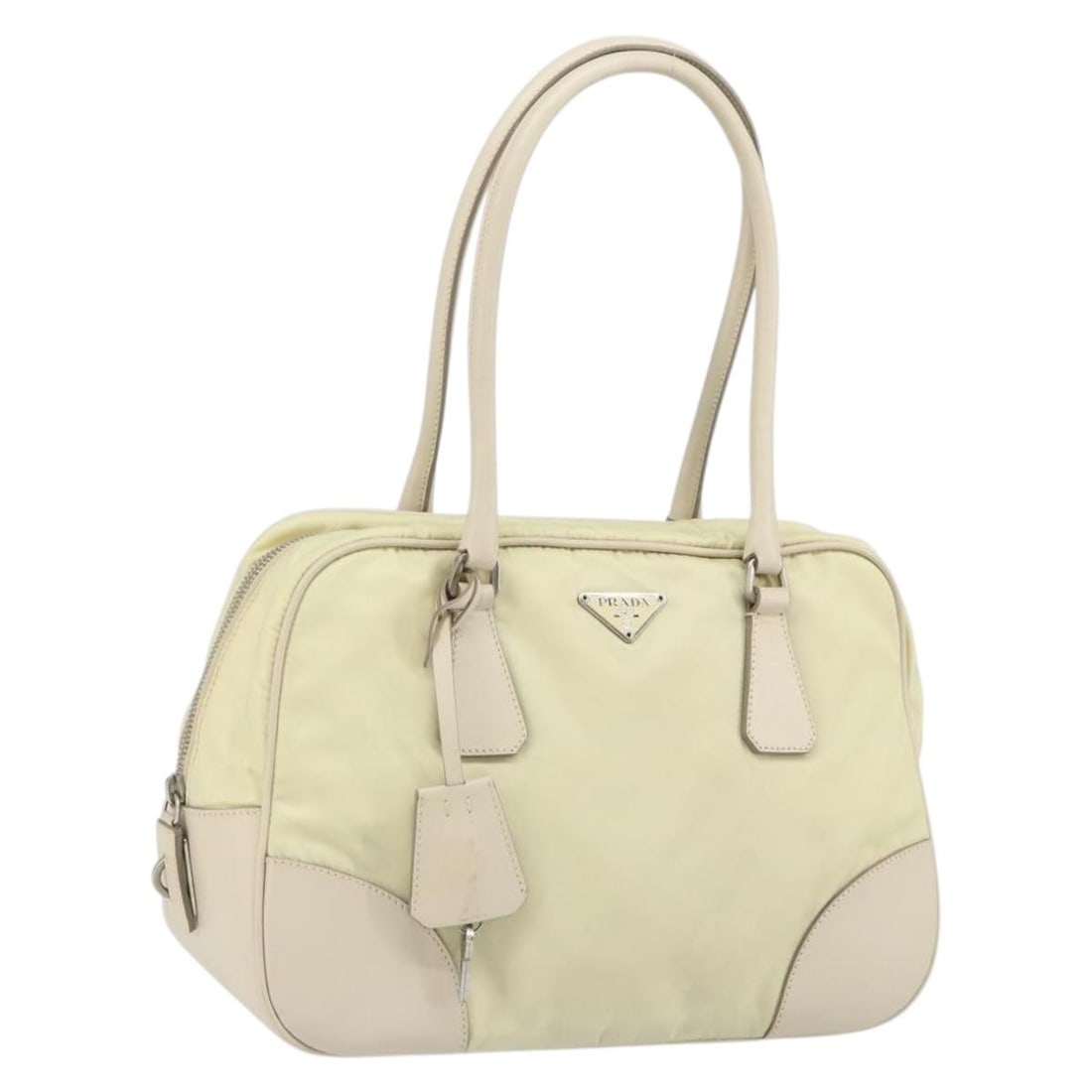 Ivory Nylon Prada Handbag with Silver Accents and Accessories: Ivory Nylon Prada Handbag with Silver Accents and Accessories This Prada handbag features an ivory and silver color scheme and is crafted from nylon. The bag includes a padlock, two keys, a clochette,