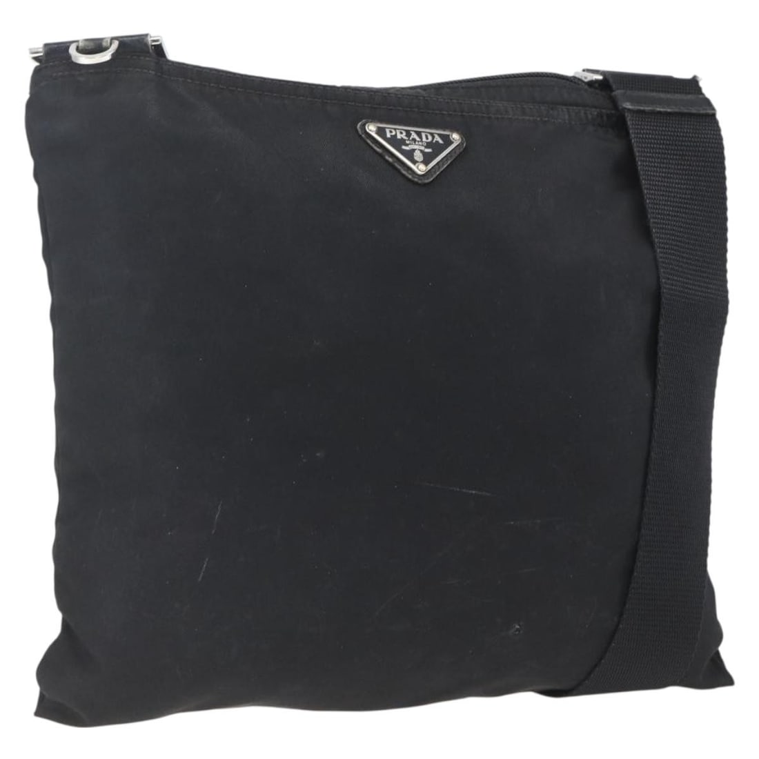 Black Nylon Prada Shoulder Bag with Silver Accents from Italy: Black Nylon Prada Shoulder Bag with Silver Accents from Italy This PRADA shoulder bag features a black nylon exterior with silver-tone accents. Designed for versatility, it offers an adjustable should