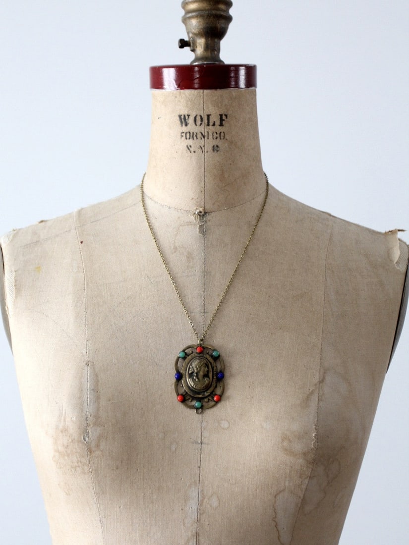 Vintage Bronze Cameo Pendant Necklace with Colorful Beads: Vintage Bronze Cameo Pendant Necklace with Colorful Beads This exquisite vintage bronze cameo necklace features a stunning pendant showcasing a woman's profile. The pendant is beautifully accented by
