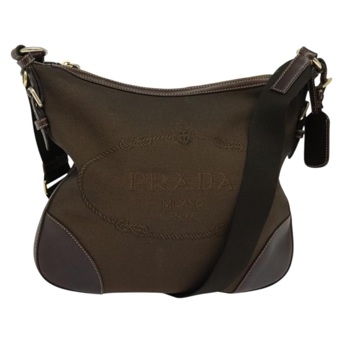 PRADA Brown Gold Canvas Shoulder Bag Made in Italy: PRADA Brown Gold Canvas Shoulder Bag Made in Italy This PRADA Shoulder Bag combines a chic brown canvas exterior with elegant gold accents, epitomizing sophisticated style. The bag measures approximat