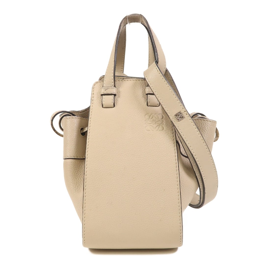Mini Hammock Calfskin 2way Shoulder Bag in Beige by Loewe: Mini Hammock Calfskin 2way Shoulder Bag in Beige by Loewe This LOEWE Mini Hammock shoulder bag features a versatile 2-way design crafted from beige calfskin leather. The bag is a regular size and show