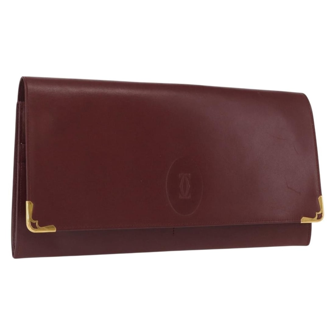 Cartier Must Line Bordeaux Leather Clutch with Gold Accents Italy: Cartier Must Line Bordeaux Leather Clutch with Gold Accents Italy This Cartier Must Line clutch bag is crafted from bordeaux leather with gold-tone accents. Made in Italy, it features a sleek silhouet