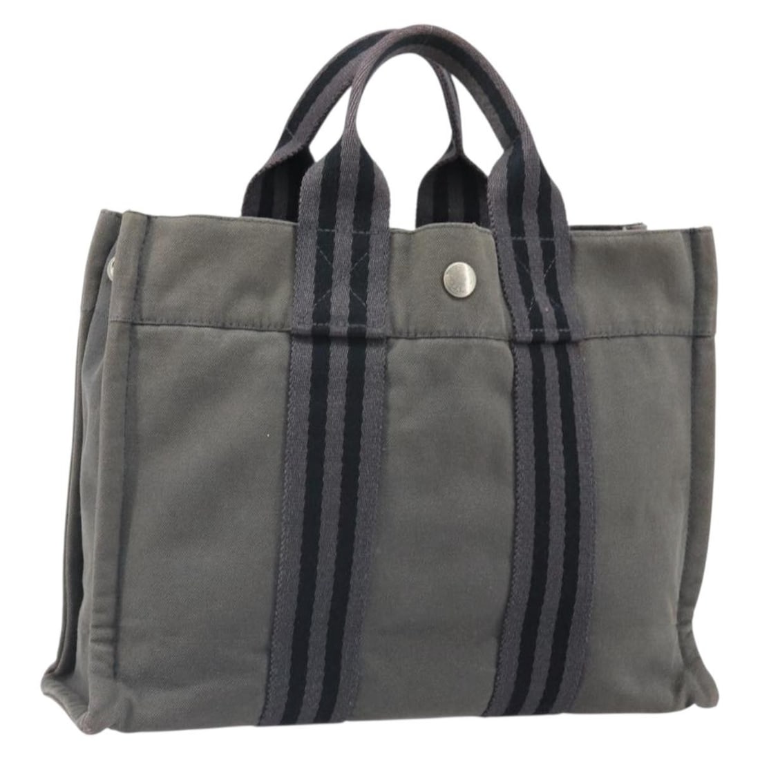 Canvas Gray Silver Fourre Tout PM Handbag by Hermes: Canvas Gray Silver Fourre Tout PM Handbag by Hermes This HERMES Fourre Tout PM hand bag features a canvas exterior in gray and silver tones. It is designed with a compact silhouette and practical hand