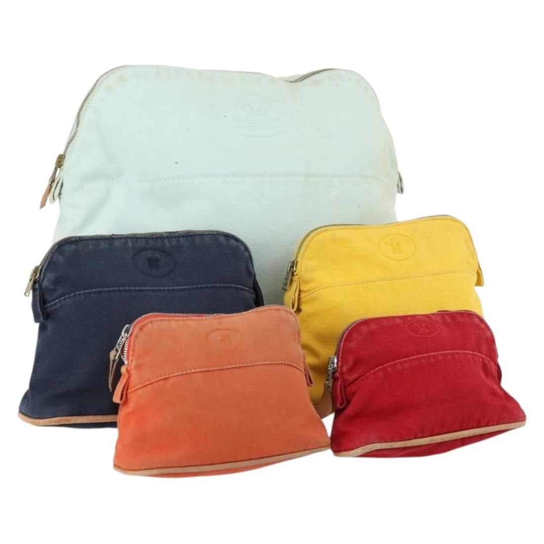 Set of 5 Hermes Canvas Bolide Pouches in Multicolor France Authentic: Set of 5 Hermes Canvas Bolide Pouches in Multicolor France Authentic This is a set of five Hermes Bolide pouches made from canvas in light blue, orange, yellow, navy, and red. The set originates from