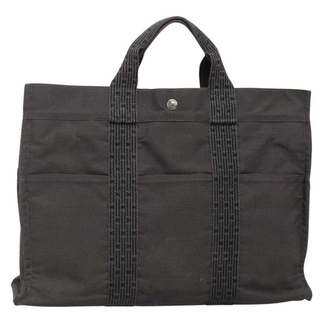 HERMES Her Line MM Hand Bag Gray Silver Canvas Made in France: HERMES Her Line MM Hand Bag Gray Silver Canvas Made in France This HERMES Her Line MM Hand Bag is a stylish and functional accessory crafted from durable canvas in a sophisticated gray and silver colo