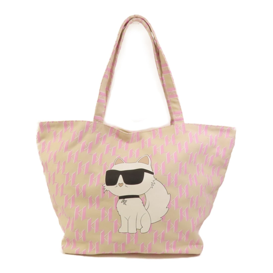 Beige Canvas Shoulder Tote by KARL LAGERFELD: Beige Canvas Shoulder Tote by KARL LAGERFELD This KARL LAGERFELD tote bag is crafted from beige canvas and designed for use as a shoulder bag. It features a spacious main compartment and a regular siz