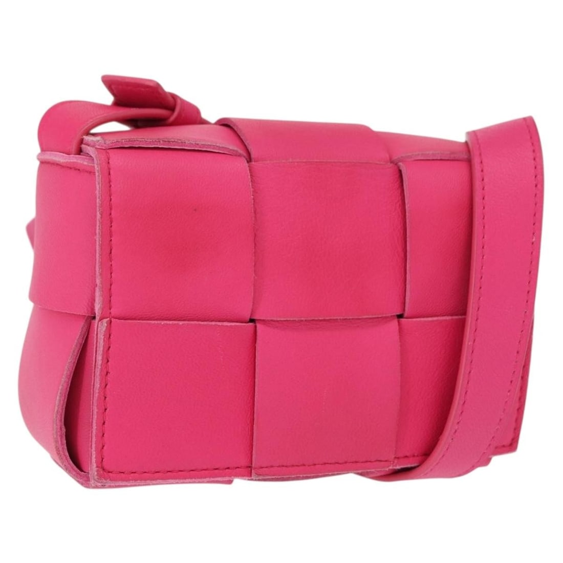 Pink Leather Maxi Intrecciato Cassette Candy Shoulder Bag by Bottega Veneta: Pink Leather Maxi Intrecciato Cassette Candy Shoulder Bag by Bottega Veneta This is a Bottega Veneta Maxi Intrecciato Cassette Candy shoulder bag crafted from pink leather. The bag features a compact
