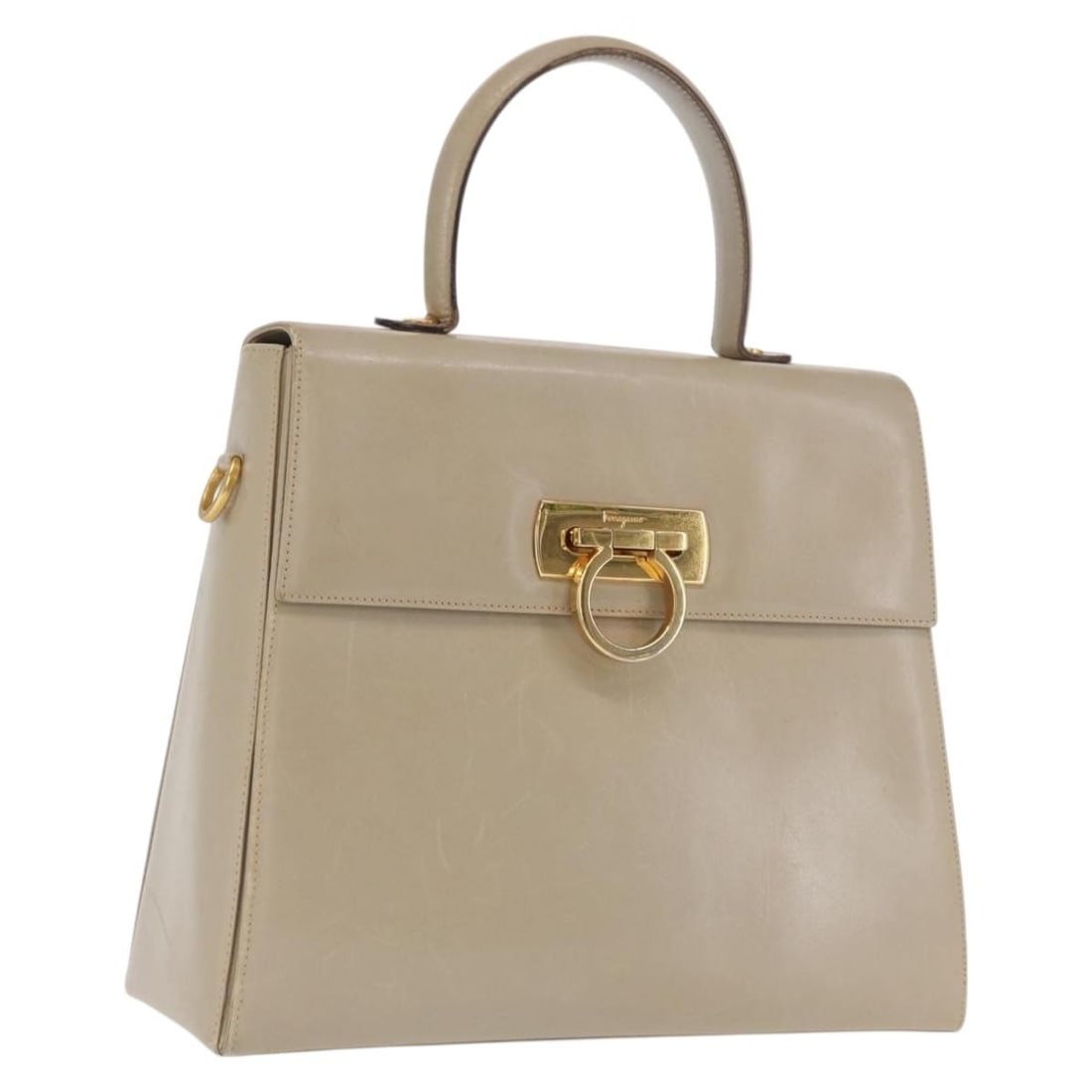 Beige Leather Gancini Handbag by Salvatore Ferragamo Gold Accent Italy: Beige Leather Gancini Handbag by Salvatore Ferragamo Gold Accent Italy This Salvatore Ferragamo Gancini handbag is crafted from beige leather with gold-tone accents. It features a structured silhouett