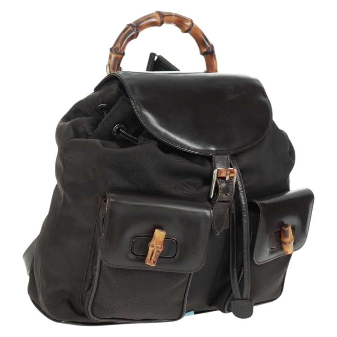 Brown Nylon GUCCI Bamboo Backpack Model 003 1119 0016 Silver Tone Hardware: Brown Nylon GUCCI Bamboo Backpack Model 003 1119 0016 Silver Tone Hardware This is a Gucci bamboo backpack crafted from brown nylon with silver-tone accents. The bag features a bamboo handle and adjus