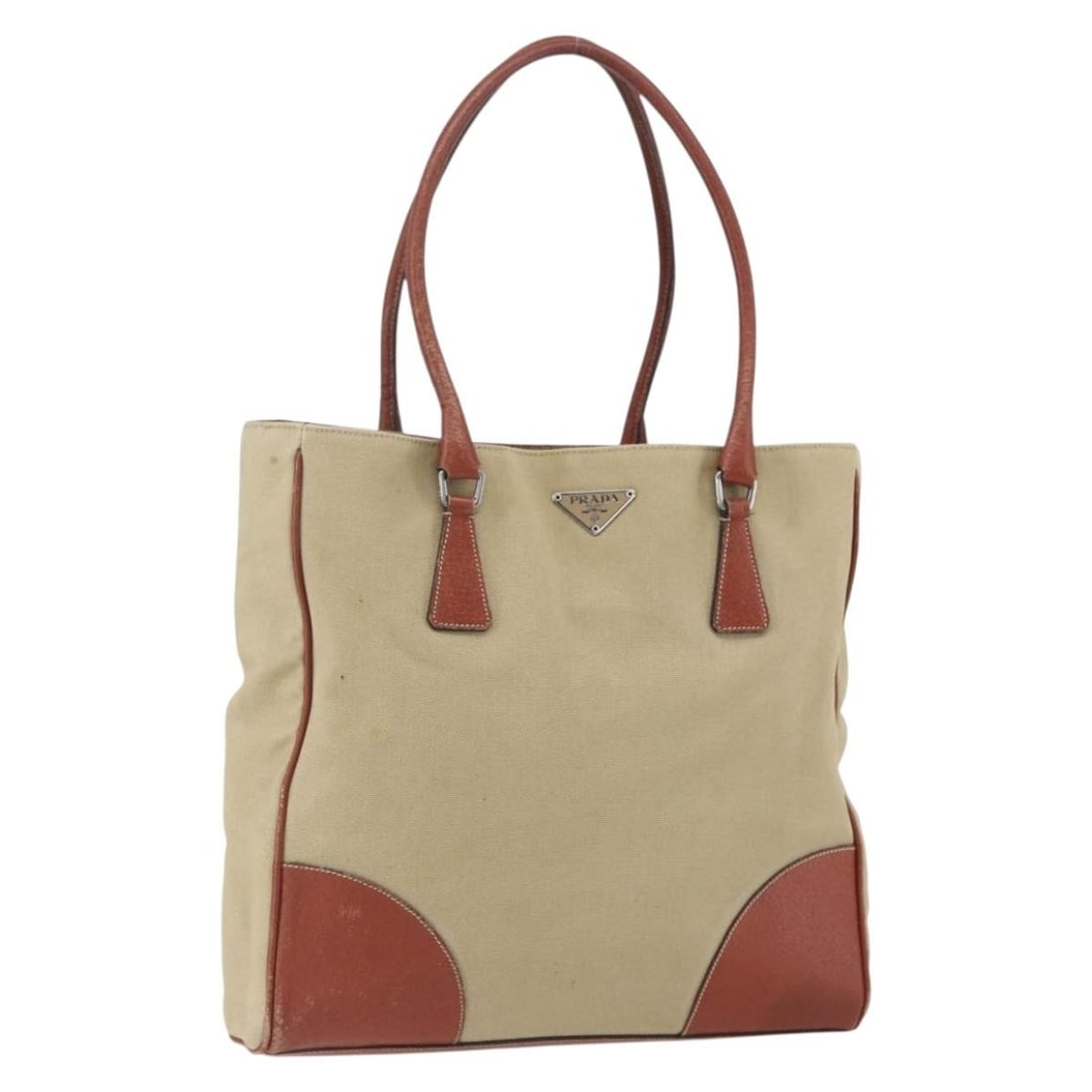 Prada Beige and Silver Canvas Tote Bag Made in Italy: Prada Beige and Silver Canvas Tote Bag Made in Italy This PRADA tote bag is crafted from beige and silver canvas and was made in Italy. It features a spacious main compartment and dual handles suitabl
