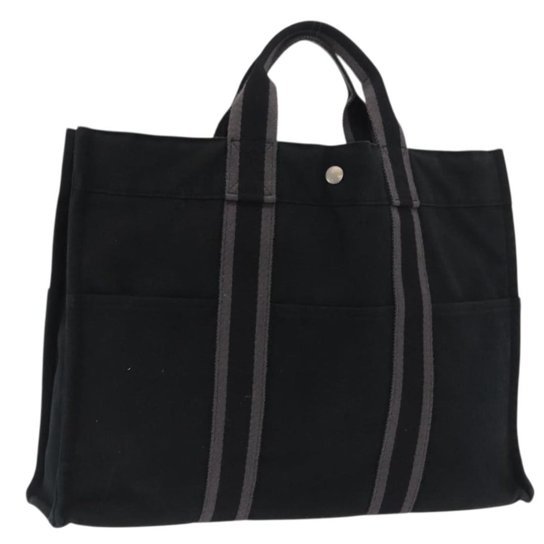 Black Canvas Fourre Tout MM Tote Bag by Hermes France: Black Canvas Fourre Tout MM Tote Bag by Hermes France This is an Hermes Fourre Tout MM hand bag crafted from black canvas. The bag features a spacious interior and sturdy handles, making it ideal for