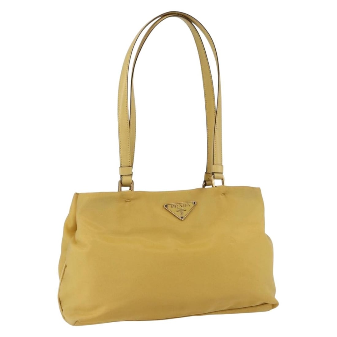 Yellow Gold Nylon Tote from PRADA Italy: Yellow Gold Nylon Tote from PRADA Italy This PRADA tote bag features a yellow and gold nylon exterior and is crafted in Italy. The bag is designed with dual handles and offers a compact and functional