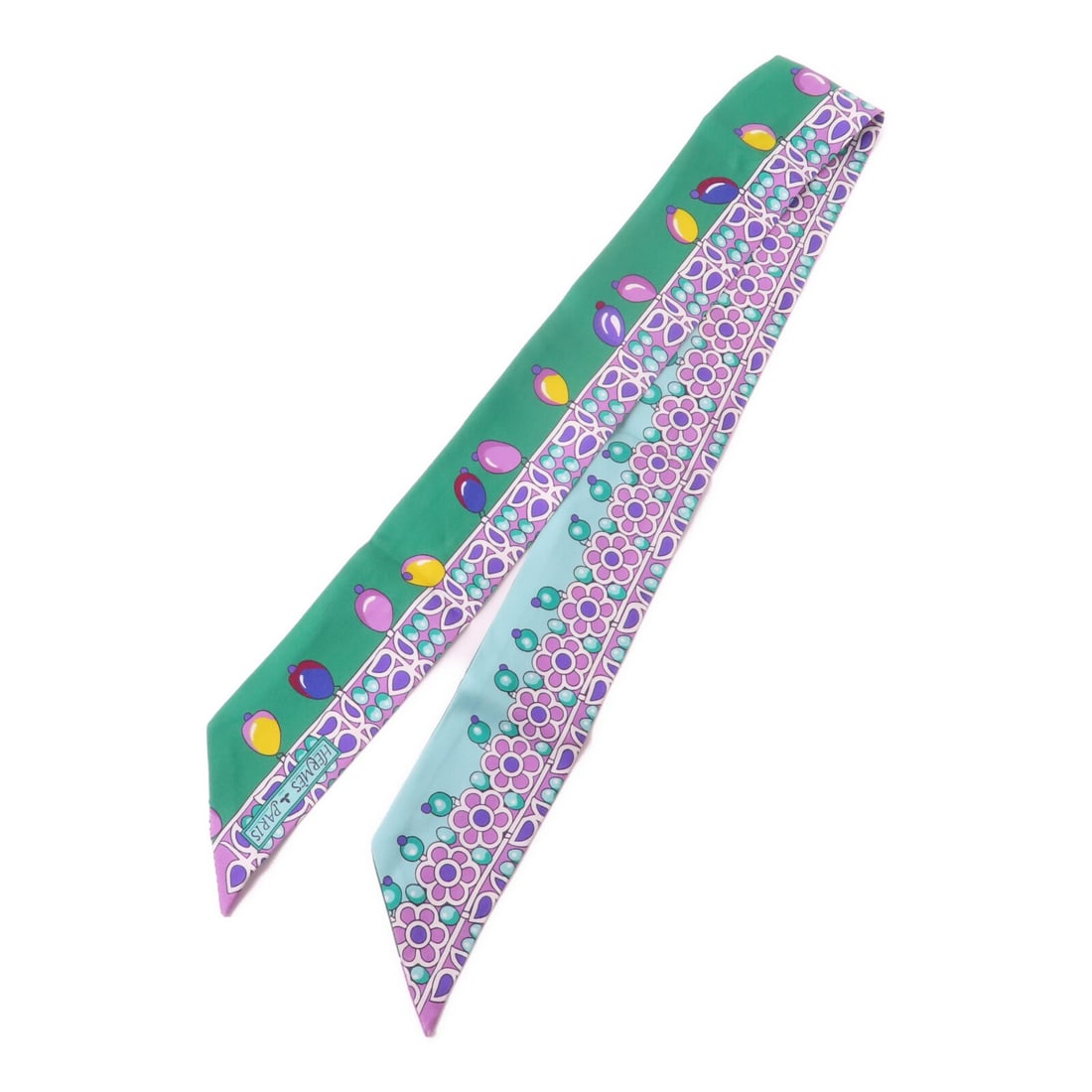 Hermes Silk Twilly Green and Purple Patterned Scarf: Hermes Silk Twilly Green and Purple Patterned Scarf This Hermes Twilly scarf features a vibrant multicolor design in shades of green and purple. Crafted from luxurious silk, it offers both elegance an