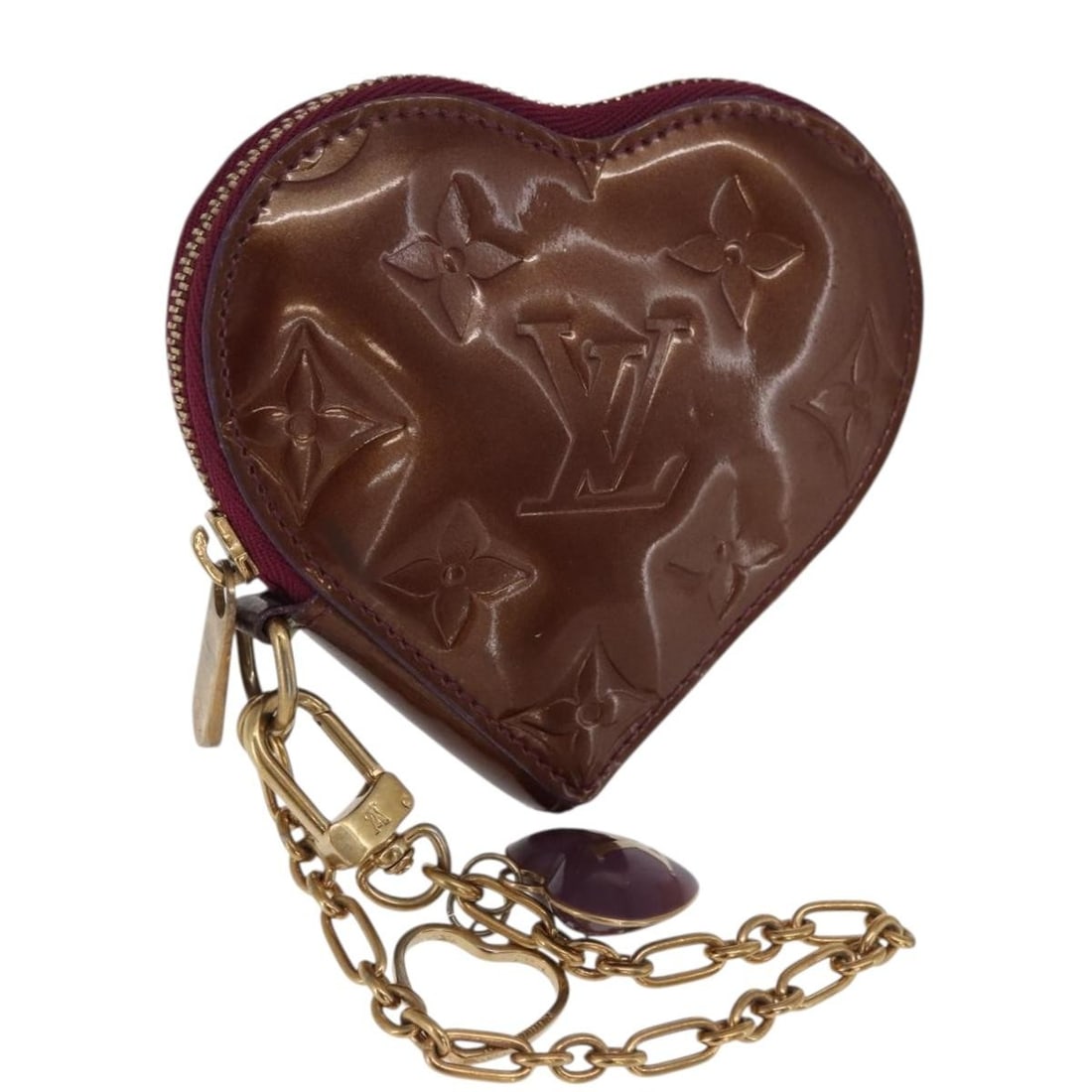 Vernis Violet Patent Leather Heart Coin Purse by Louis Vuitton M93563: Vernis Violet Patent Leather Heart Coin Purse by Louis Vuitton M93563 This Louis Vuitton Vernis Porte Monnaie Coeur coin purse is crafted from violet patent leather and made in Italy. The heart-shaped
