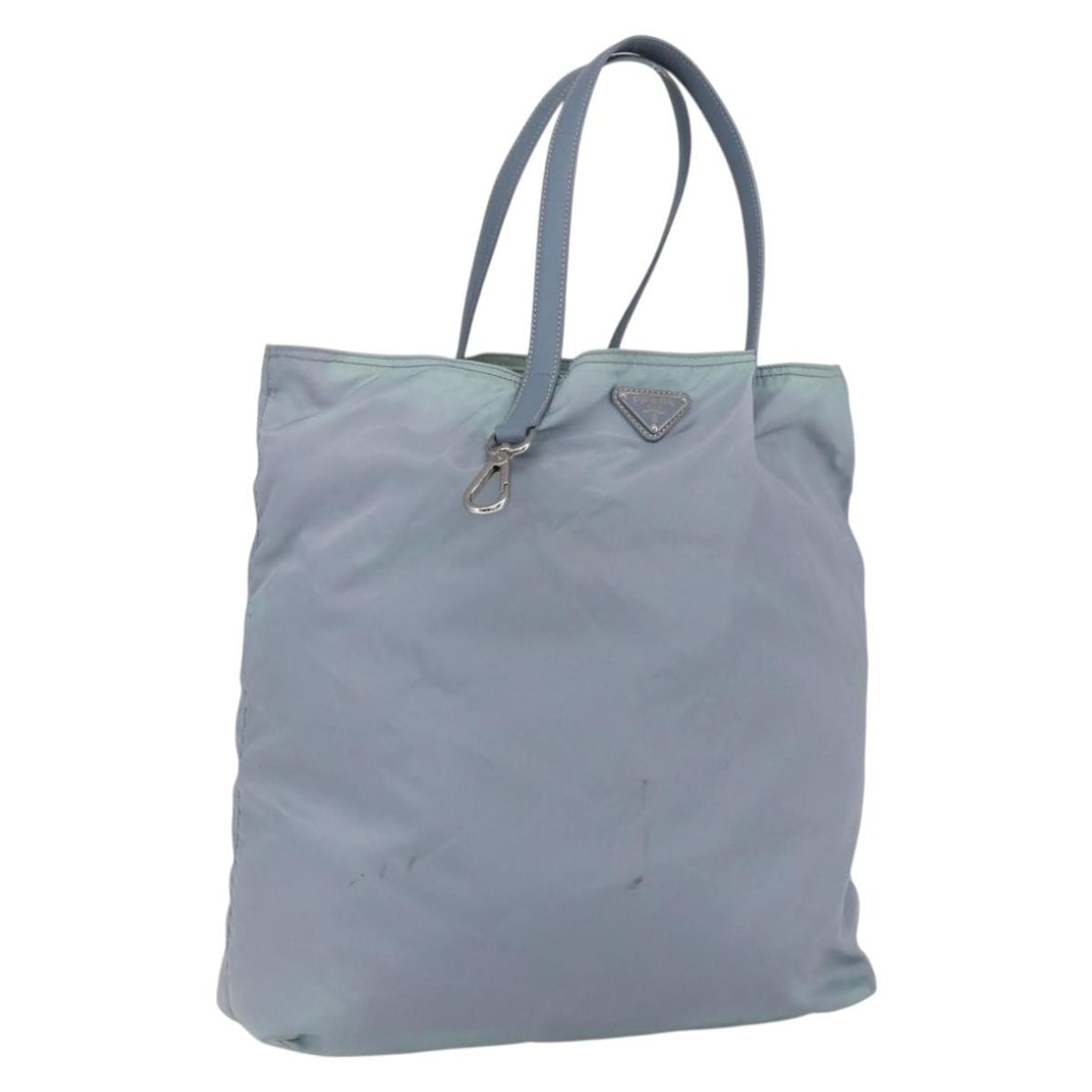 Light Blue Nylon PRADA Handbag with Silver Accents Made in Italy: Light Blue Nylon PRADA Handbag with Silver Accents Made in Italy This PRADA handbag is crafted from light blue and silver nylon, offering a stylish and practical design. Made in Italy, it features a s