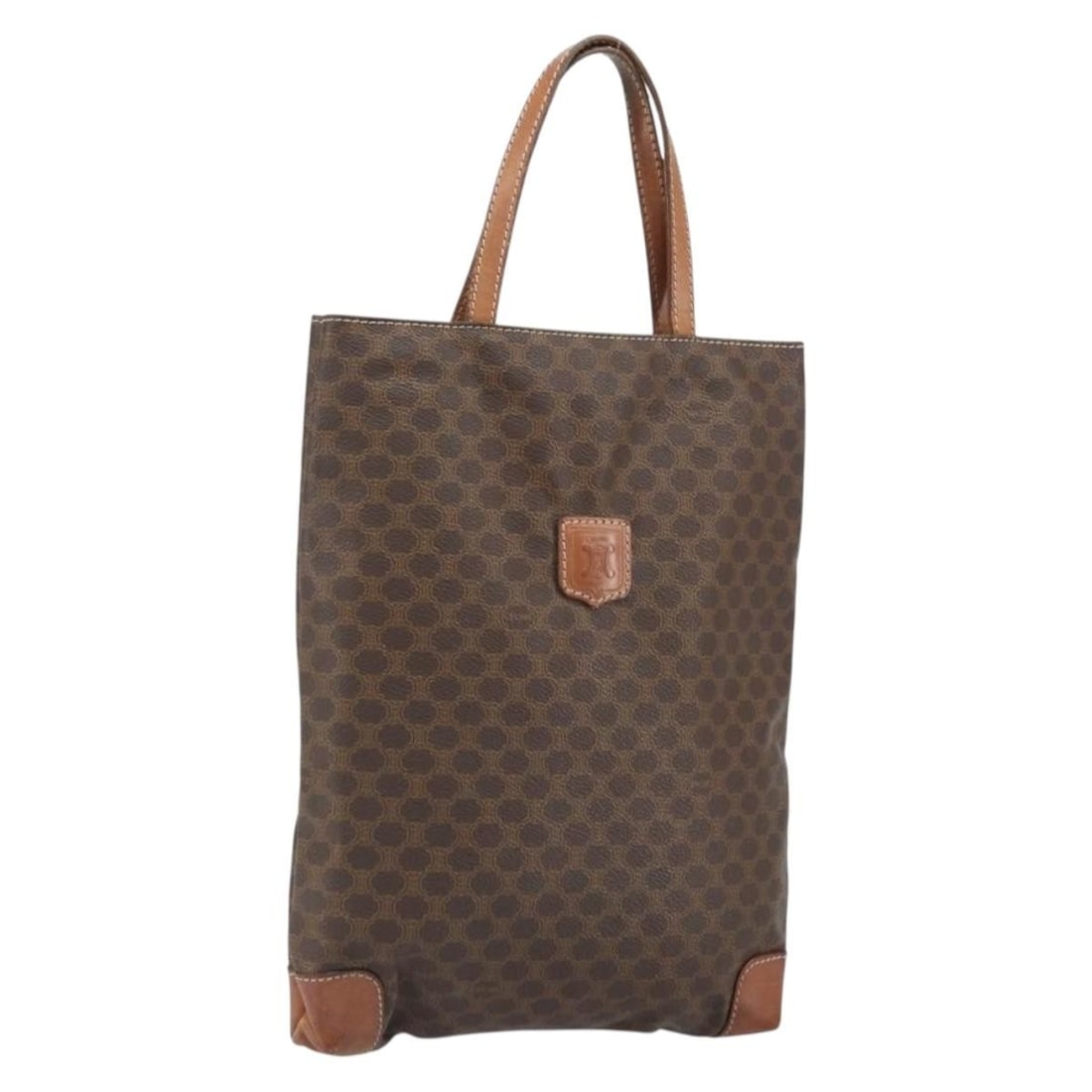 Brown PVC Leather Macadam Canvas Handbag by CELINE Gold Accents: Brown PVC Leather Macadam Canvas Handbag by CELINE Gold Accents This CELINE Macadam canvas hand bag features a brown and gold PVC leather exterior with the iconic Macadam pattern. Crafted in Italy, th