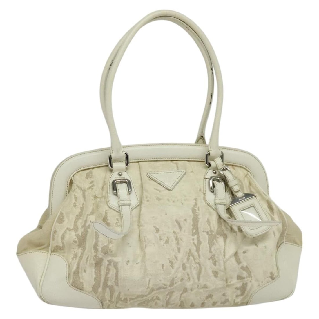 PRADA Silver White Canvas Shoulder Bag with Name Tag Italy Auth FM4672: PRADA Silver White Canvas Shoulder Bag with Name Tag Italy Auth FM4672 This authentic PRADA shoulder bag combines elegance with practicality, featuring a stylish silver and white canvas exterior. Idea