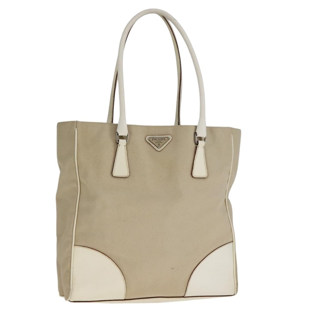 PRADA Beige White Silver Canvas Tote Bag Made in Italy: PRADA Beige White Silver Canvas Tote Bag Made in Italy This stylish PRADA tote bag is a perfect blend of sophistication and practicality. Crafted from durable canvas, it showcases an elegant color pal