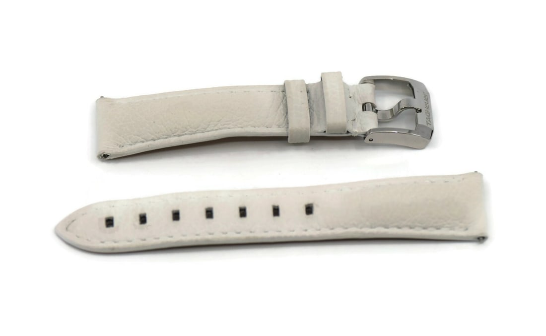 Authentic TAG Heuer 18mm White Leather Wristwatch Strap: Authentic TAG Heuer 18mm White Leather Wristwatch Strap Enhance your timepiece with this authentic Tag Heuer white leather strap, designed specifically for wristwatches. Crafted from high-quality leat