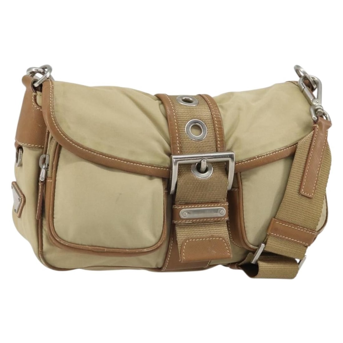 Beige Nylon Prada Shoulder Bag with Silver Tone Accents: Beige Nylon Prada Shoulder Bag with Silver Tone Accents This PRADA shoulder bag is crafted from beige nylon with silver-tone accents. Made in Italy, the bag features a spacious main compartment and an