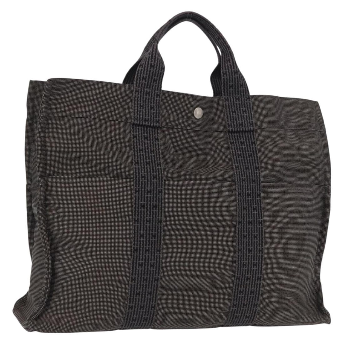 Her Line MM Canvas Gray Silver Handbag by Hermes: Her Line MM Canvas Gray Silver Handbag by Hermes This is an Hermes Her Line MM hand bag crafted from gray and silver canvas. The bag was made in France and features a spacious interior, double handles