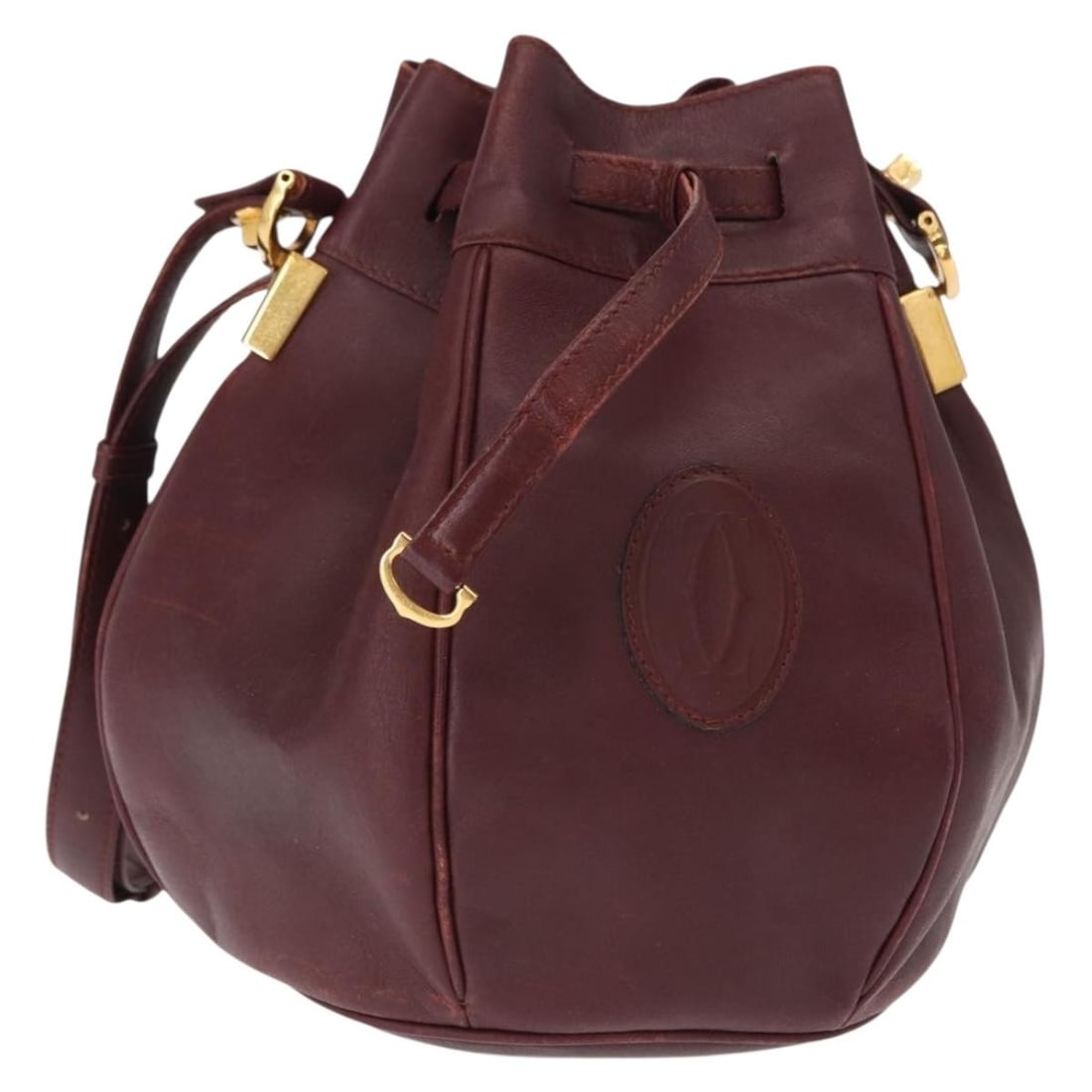 CARTIER Must Line Bordeaux Leather Shoulder Bag Gold Accents: CARTIER Must Line Bordeaux Leather Shoulder Bag Gold Accents This exquisite CARTIER Must Line Shoulder Bag showcases a luxurious bordeaux leather exterior accented with gold hardware. Crafted in Spain