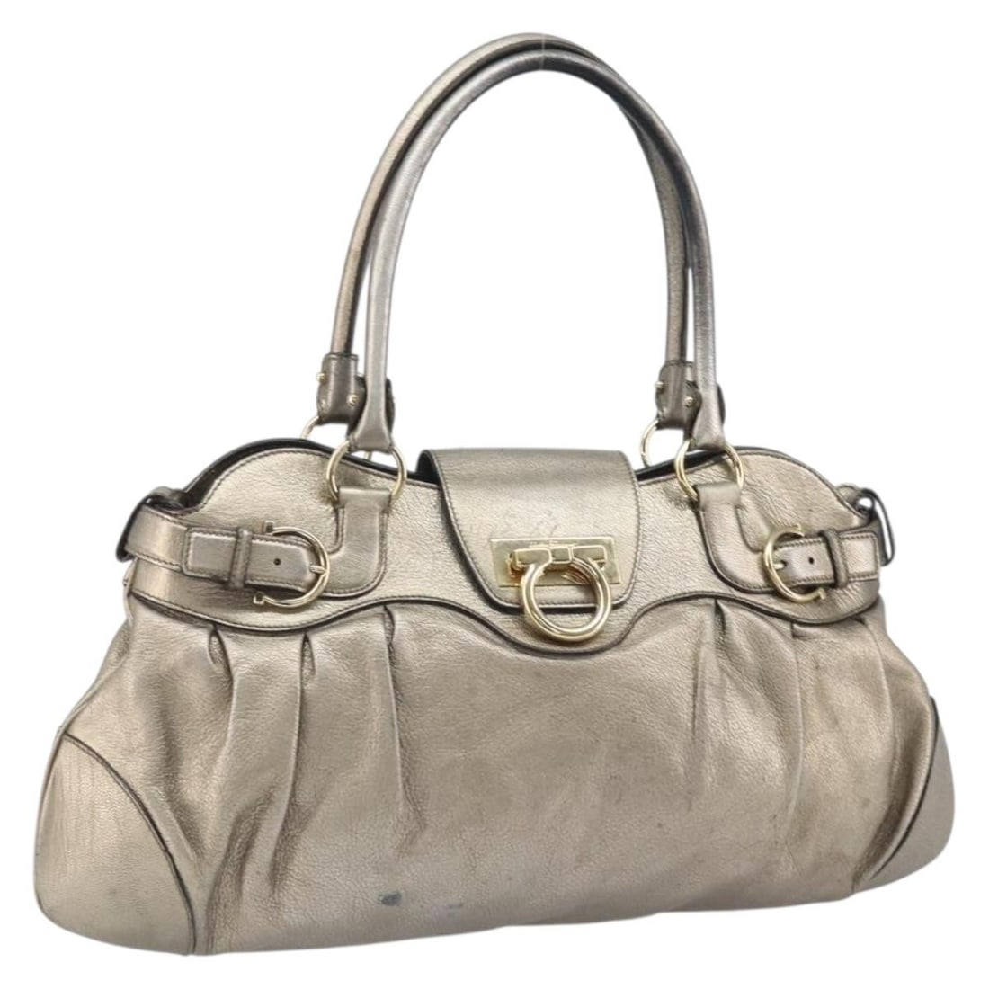 Ferragamo Gancini Leather Gold Handbag Made in Italy: Ferragamo Gancini Leather Gold Handbag Made in Italy This Salvatore Ferragamo Gancini handbag features a gold leather exterior and is crafted in Italy. The bag has a structured silhouette with a singl