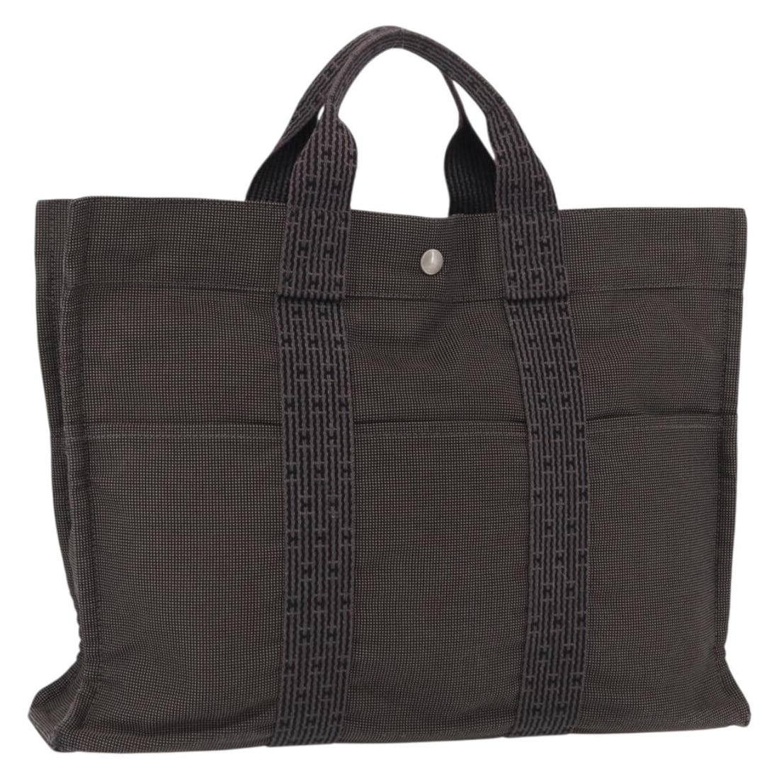 Gray Canvas Her Line MM Tote by Hermes France: Gray Canvas Her Line MM Tote by Hermes France This Hermes Her Line MM hand bag features a gray and silver canvas exterior with silver-tone hardware. The bag has a spacious interior and dual handles, m