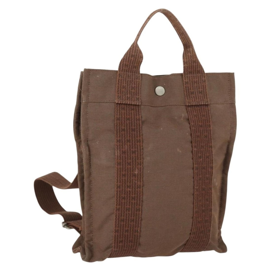 Hermes Her Line Add PM Brown Canvas Backpack with Silver Accents: Hermes Her Line Add PM Brown Canvas Backpack with Silver Accents This Hermes Her Line Add PM backpack features a brown and silver canvas exterior. The bag shows signs of heavy use, including loss of s