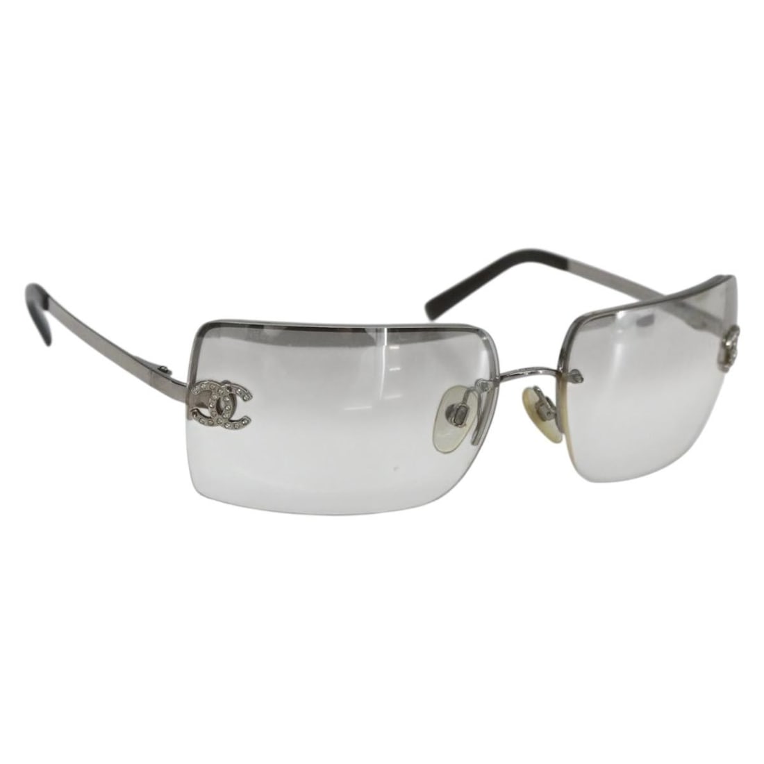 Clear Metal CHANEL Sunglasses with CC Logo Made in Italy: Clear Metal CHANEL Sunglasses with CC Logo Made in Italy These CHANEL sunglasses feature a clear metal frame with the iconic CC detail. Made in Italy, they measure approximately 5.1 inches in width an