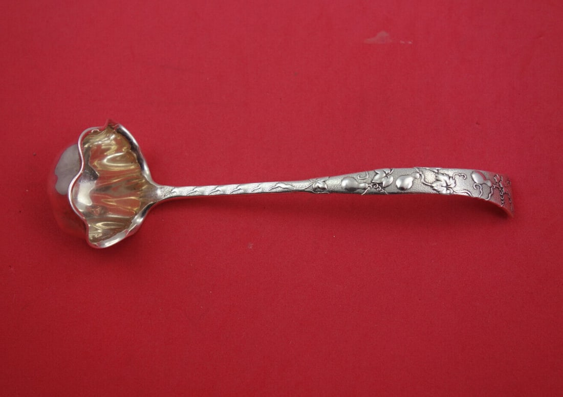 Tiffany & Co. Vine Sterling Silver Sauce Ladle with Gourd Motif: Tiffany & Co. Vine Sterling Silver Sauce Ladle with Gourd Motif This exquisite sauce ladle is part of the iconic Vine pattern by Tiffany & Co. Crafted from sterling silver, it features a scalloped bow