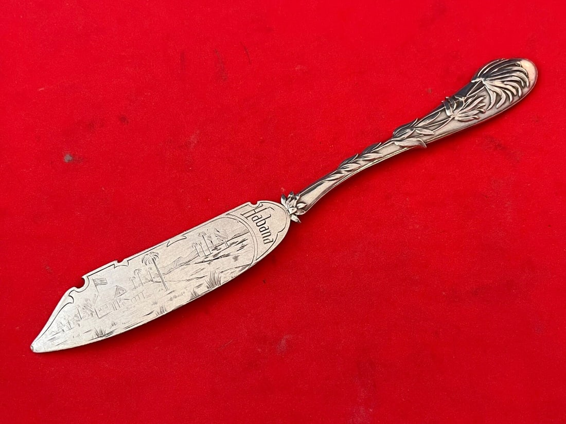 Gorham Palm Cheese Knife .900 Silver with Engraved Habana Design 7 1/8": Gorham Palm Cheese Knife .900 Silver with Engraved Habana Design 7 1/8" This exquisite Palm by Scheid cheese knife is crafted from .900 silver, featuring a beautifully designed flat handle and an engr