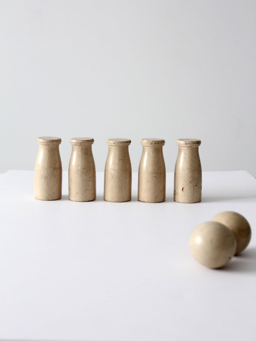 Five Pin Wooden Milk Bottle Skittles Game With Two Balls Vintage Set: Five Pin Wooden Milk Bottle Skittles Game With Two Balls Vintage Set This vintage wooden skittles game set features five turned pins designed in the shape of milk bottles and two solid wooden balls. E