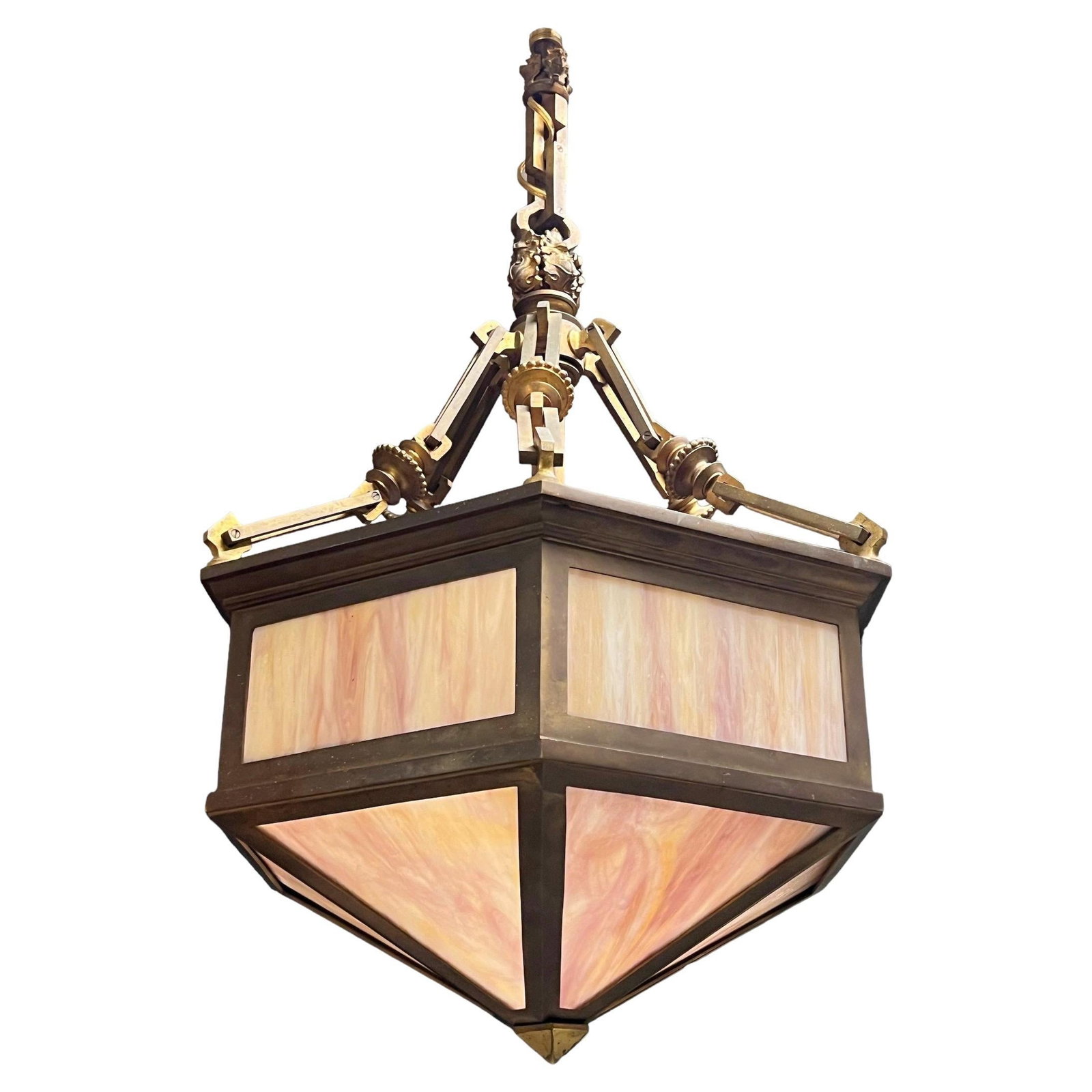 Arts and Crafts Era Bronze Hexagon Pendant Lamp with Pink Slag Glass Panels: Arts and Crafts Era Bronze Hexagon Pendant Lamp with Pink Slag Glass Panels This early 20th-century chandelier features a distinctive hexagonal design crafted from bronze and slag glass in pink tones.