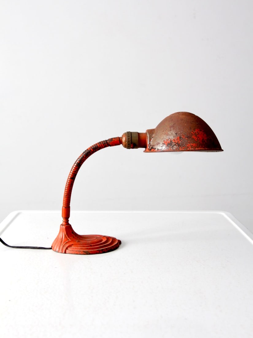 1920s Art Deco Gooseneck Metal Desk Lamp With Red Painted Finish: 1920s Art Deco Gooseneck Metal Desk Lamp With Red Painted Finish This antique Art Deco gooseneck desk lamp from the 1920s to 1930s features a sculptural curved neck and a metal shade, highlighted by i