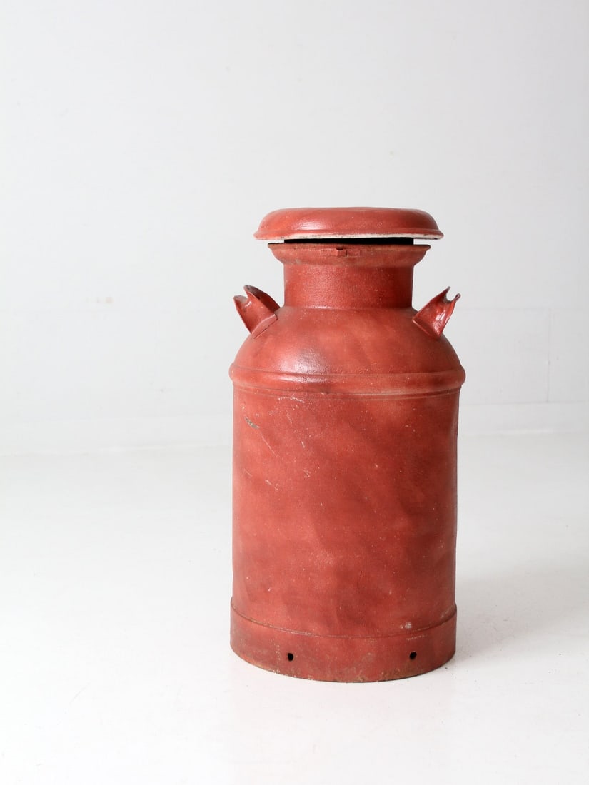 Rustic Antique Barn Red Milk Can 25 Inch Decorative Accent: Rustic Antique Barn Red Milk Can 25 Inch Decorative Accent This antique milk can features a charming barn red paint that enhances its rustic appeal. The piece exhibits beautiful weathering and natural