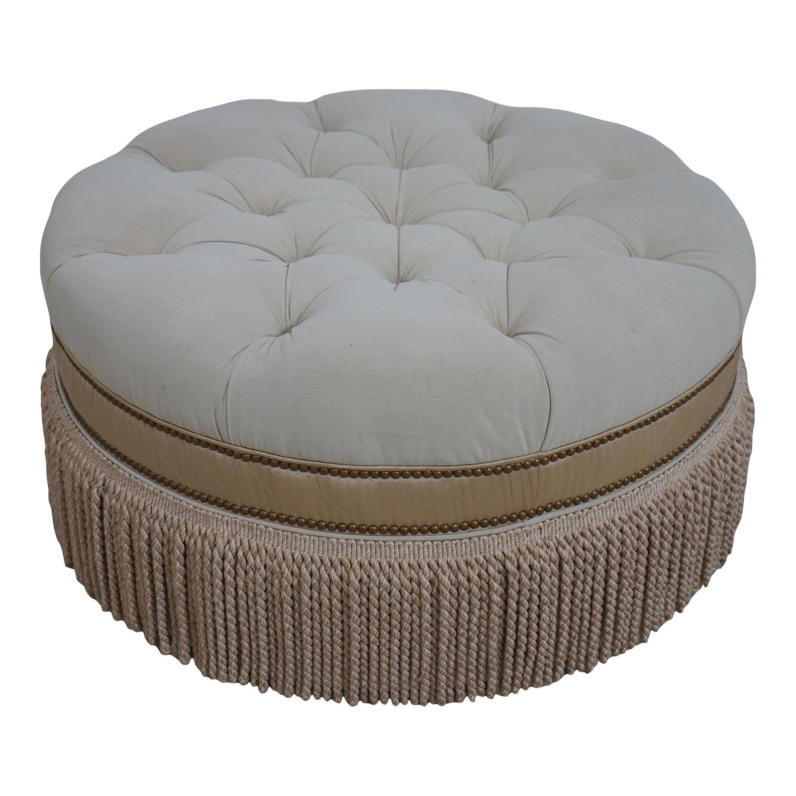 White Suede Round Ottoman with Tufted Seat and Tassel Trim: White Suede Round Ottoman with Tufted Seat and Tassel Trim This round ottoman features high-quality construction with a tufted suede seat, complemented by decorative tassel trim. The ottoman is finish