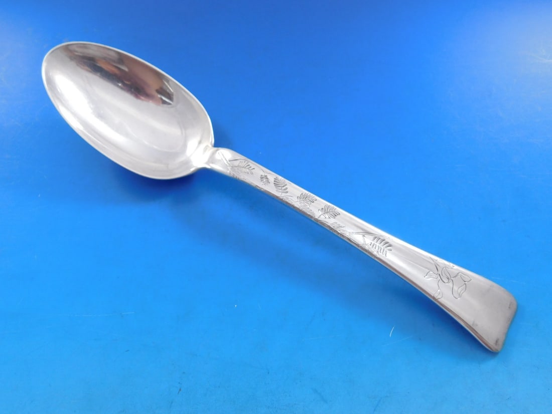 Tiffany Sterling Silver Serving Spoon Lap Over Edge Fern Leaves 8 5/8": Tiffany Sterling Silver Serving Spoon Lap Over Edge Fern Leaves 8 5/8" This exquisite serving spoon from Tiffany & Co. features a stunning lap over edge design with delicate fern leaves, showcasing th