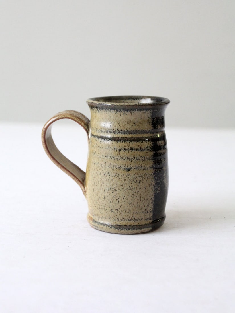 Handmade Vintage Studio Pottery Mug Two-Tone Glaze 4.75 Inch: Handmade Vintage Studio Pottery Mug Two-Tone Glaze 4.75 Inch This vintage handmade studio pottery mug showcases a stunning two-tone glaze featuring warm beige and charcoal hues, beautifully blending e