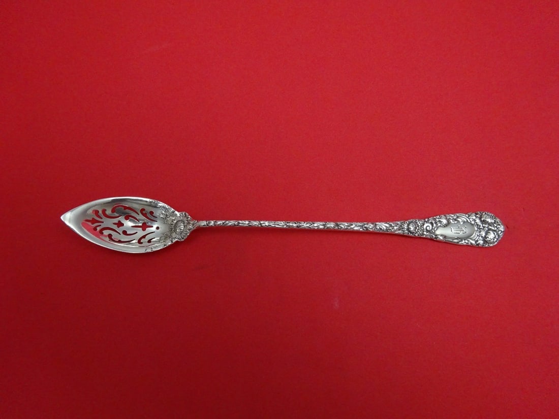 Durgin Chrysanthemum Sterling Silver Pierced Olive Spoon 6 1/8": Durgin Chrysanthemum Sterling Silver Pierced Olive Spoon 6 1/8" This exquisite serving spoon is a stunning example of the Chrysanthemum pattern by Durgin, crafted from high-quality sterling silver. Me